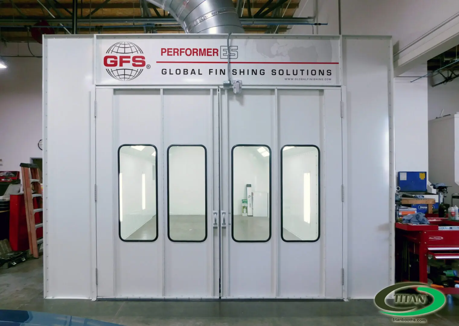 A white spray booth with two windows and one door.