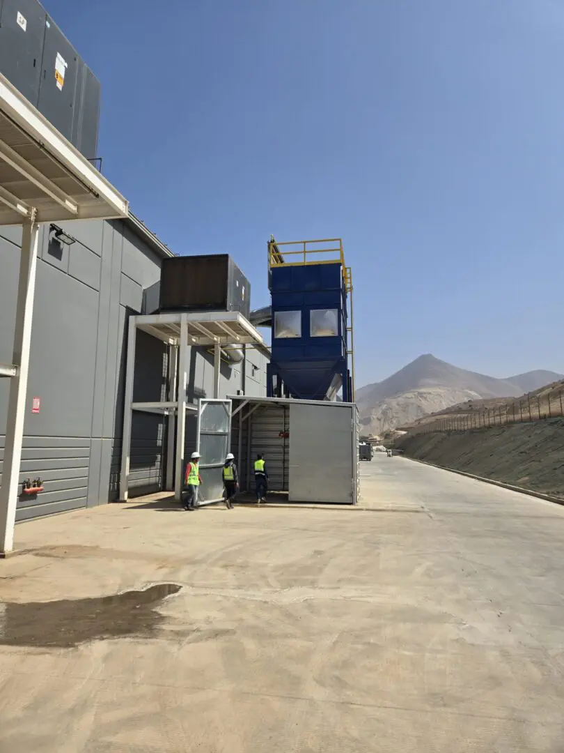 A building with a large blue container on the side of it.