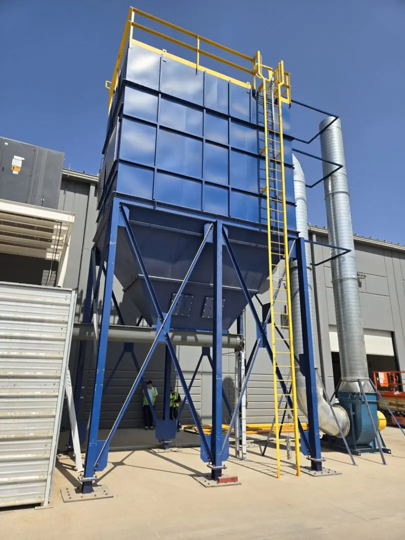 A large blue and yellow building with a big blue tower